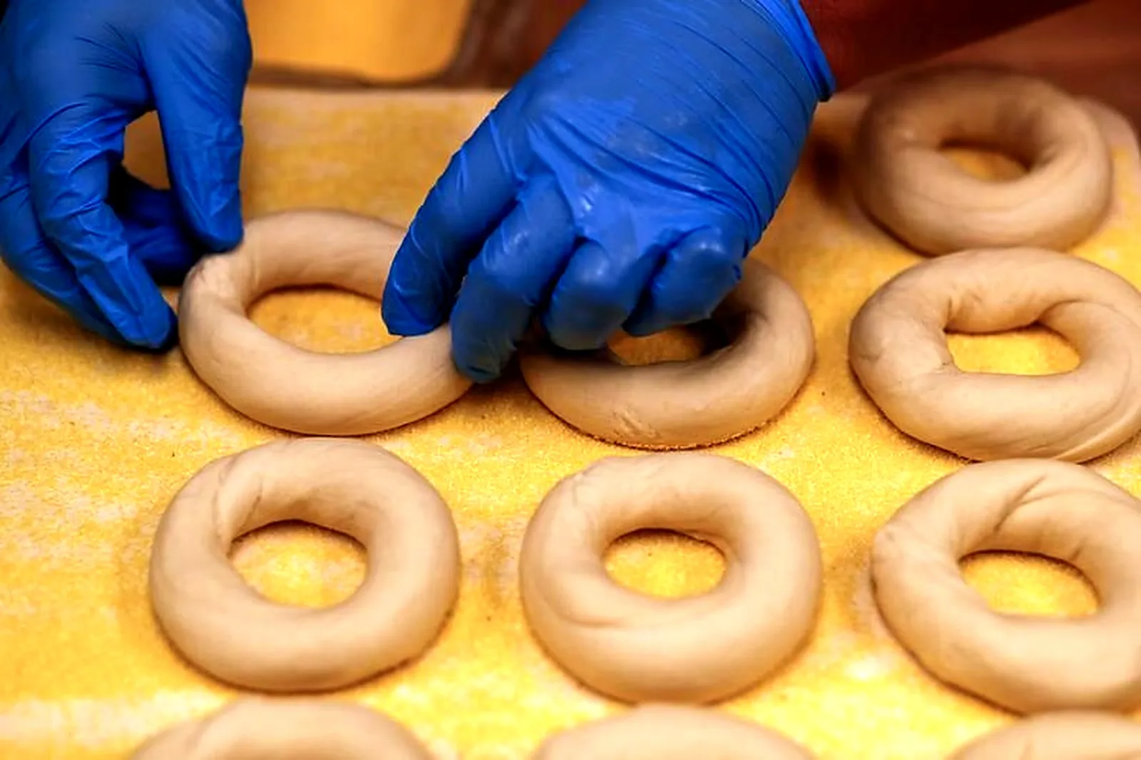 A cook adds water to plain bagel dough in the Gotham Bagels kitchen at 1212 N. Dearborn St. in Chicago