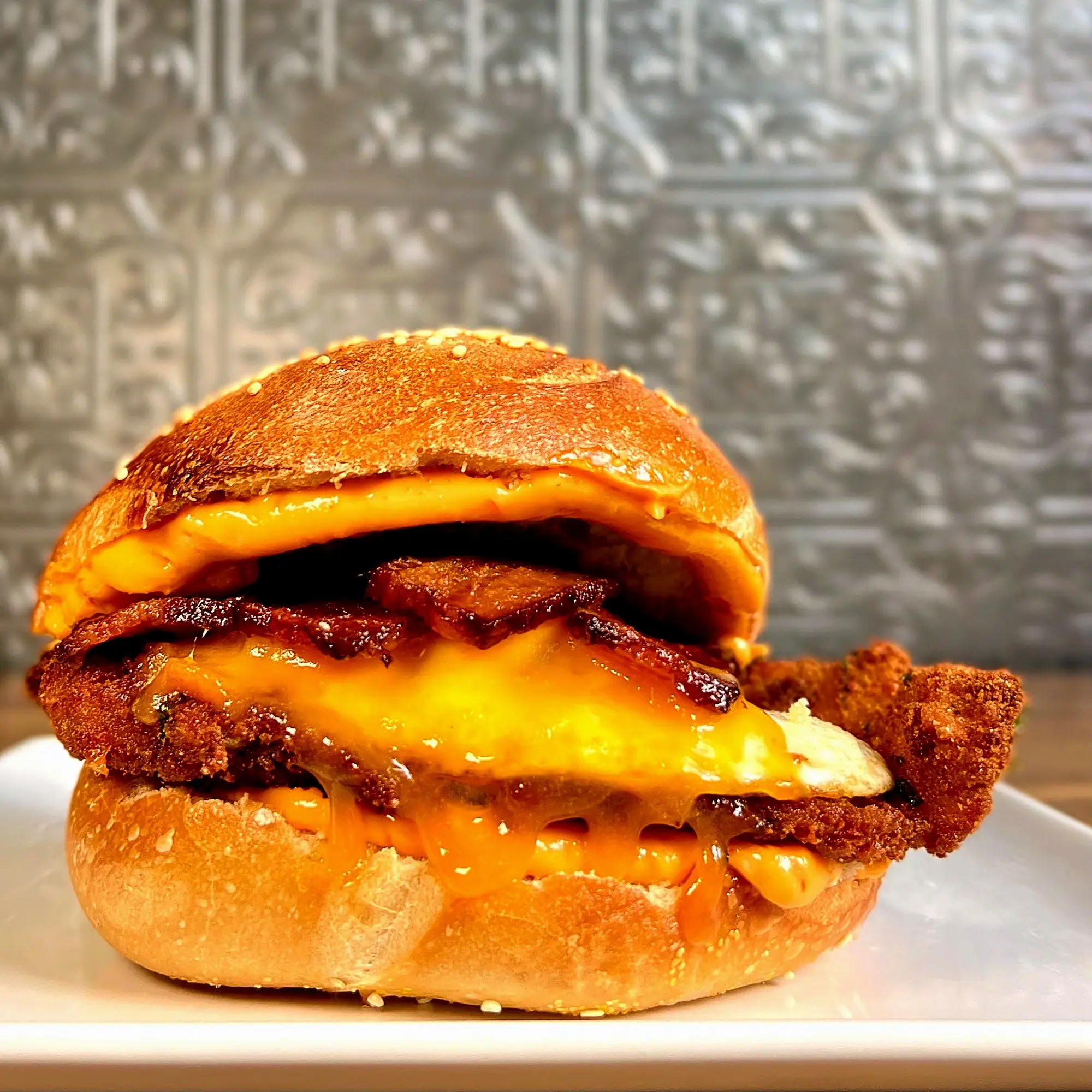 The OMFG: fried chicken, bacon, a fried egg and melted cheddar stacked on a sesame bagel