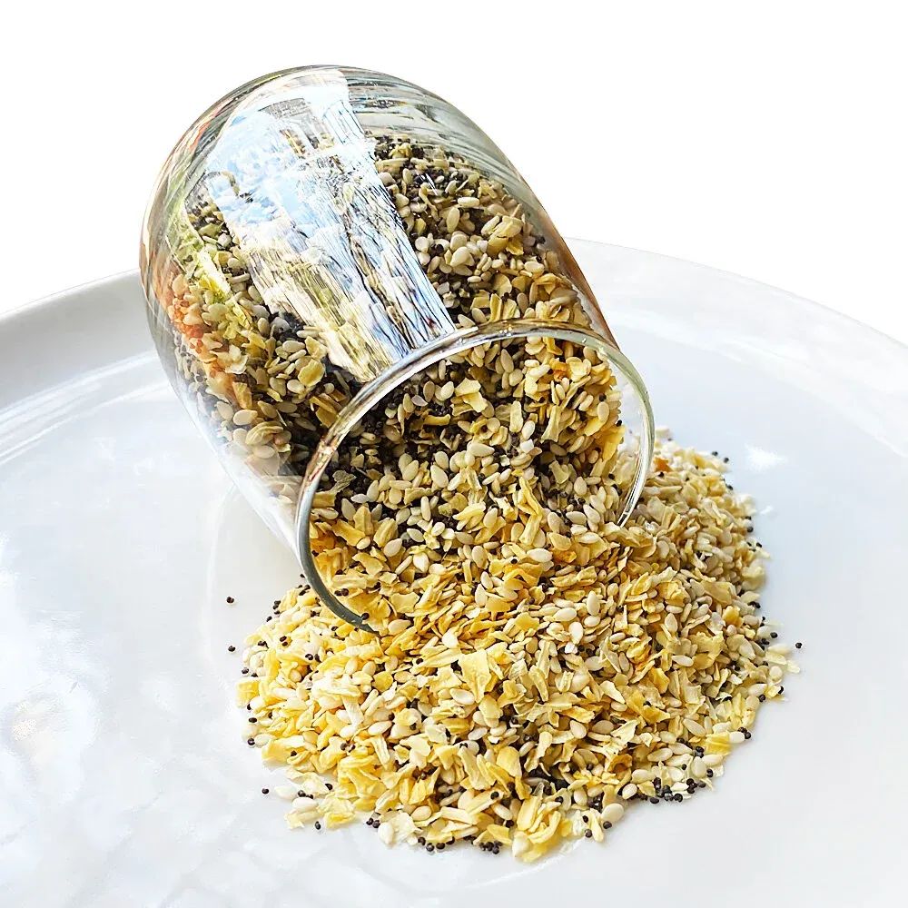 Glass jar tipped over, spilling everything seasoning of sesame, poppy seeds, dried onion and garlic onto a white plate
